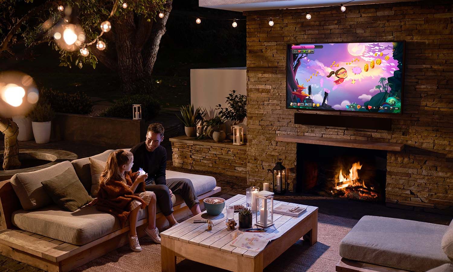 parent and child sit outside watching TV